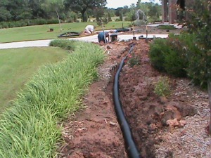 Drain Pipe running across a flower bed in Norman